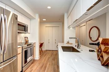 A modern kitchen with stainless steel appliances and wooden accents.